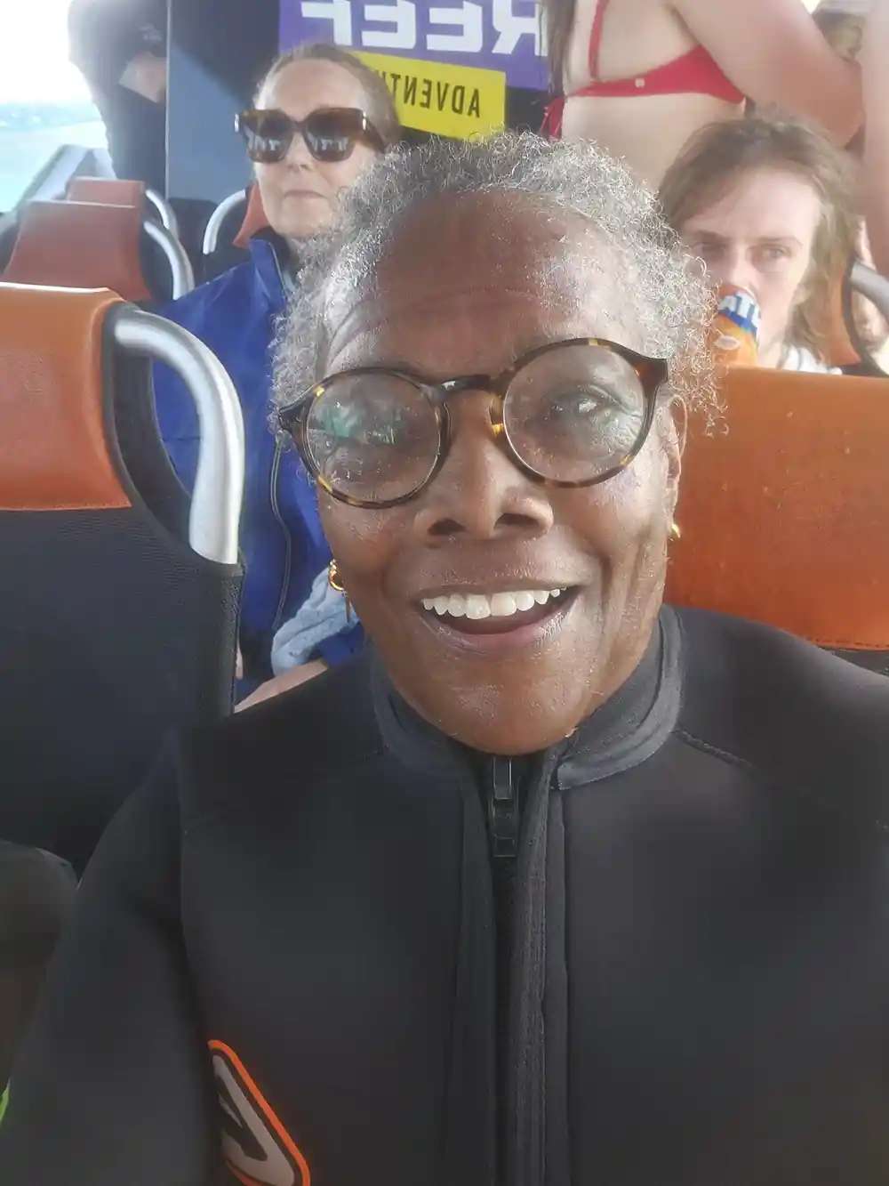 A guest smiling in the boat's cabin on the way out